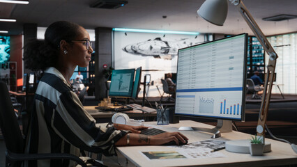 African Female Manager Using Desktop Computer With Analytics Software wth Financial Reports. Woman...