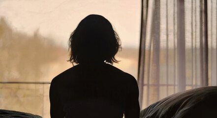 woman in an abusive relationship. looking out of the window