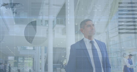 Fototapeta premium Image of financial data processing over business people