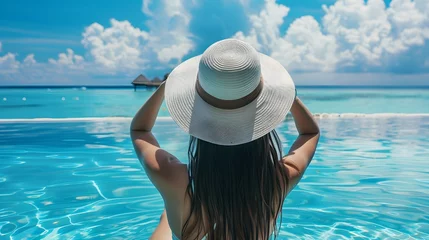 Papier Peint photo Bora Bora, Polynésie française Woman with hat at beach pool in Maldives 