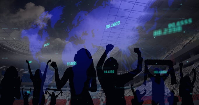 Multiple changing numbers over world map over silhouette of fans cheering against sports stadium