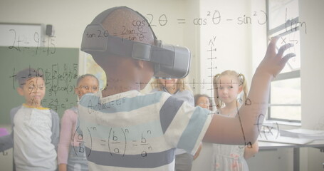 Image of mathematical equations over schoolchildren using vr headsets