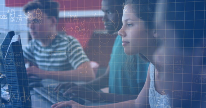 Image of mathematical equations over schoolchildren using computers
