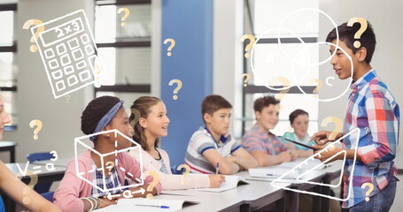 Image of school icons over diverse schoolchildren in classroom