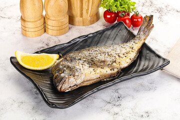 Baked Dorado fish served lemon