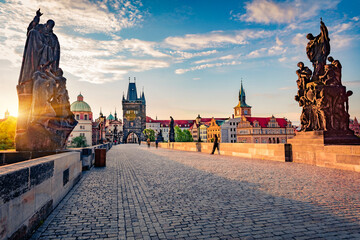 Stunning spring sunrise on Charles bridge over Vltava river (Karluv Most) with statues and Prague castle. Attractive morning cityscape in Prague, Czech Republic, Europe. Traveling concept background..