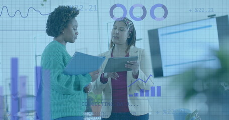 Coding and data processing on interface over diverse female colleagues discussing at office