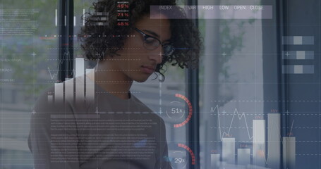 Image of statistics and data processing over man using smartphone