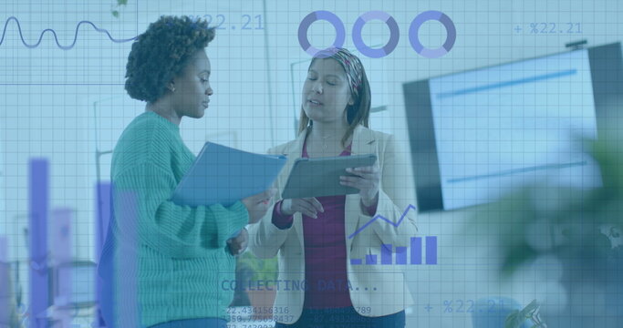 Coding and data processing on interface over diverse female colleagues discussing at office