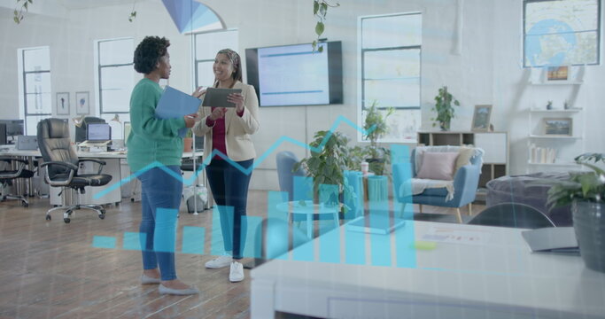 Data processing on interface over diverse female colleagues discussing at casual office