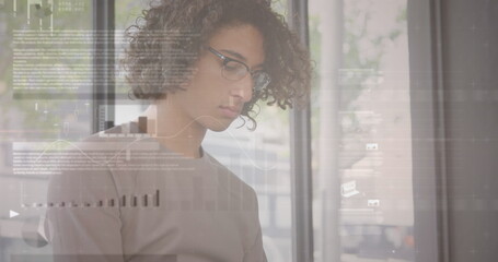 Image of statistics and data processing over man using smartphone