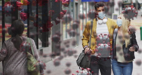 Image of virus cells over caucasian couple wearing face mask