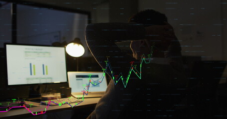 Image of financial data processing over biracial businessman working in office