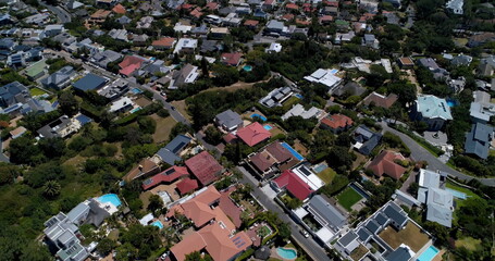 Fototapeta premium General view of cityscape with houses, mountains, sea and blue sky