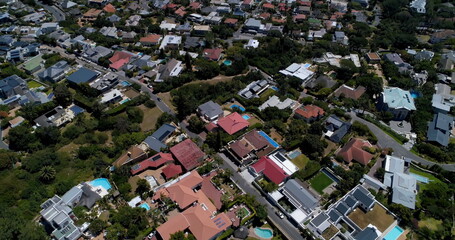 General view of cityscape with houses, mountains, sea and blue sky