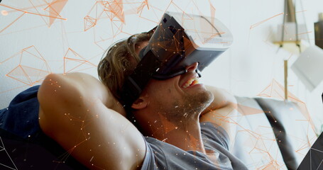 Image of man wearing Virtual Reality headset laughing with tunnel of pink network of connections