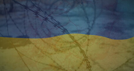 Obraz premium Image of flag of ukraine over field and barbed wire