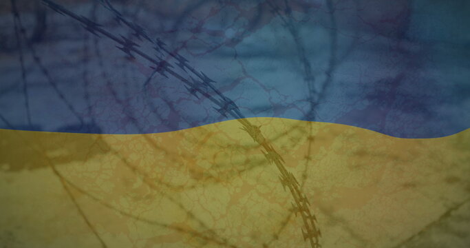 Naklejki Image of flag of ukraine over field and barbed wire