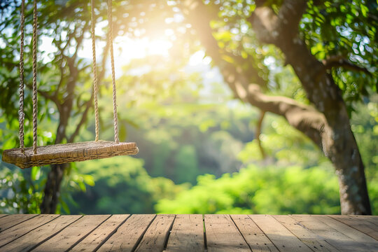 wooden table top and a swing with a blurred image of nature on a bokeh background are used to showcase products or anything else. The concept of a summer vacation in nature, a family picnic
