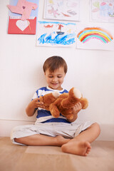 Floor, smile or child with teddy bear for playing or development and growth in home in playroom. Happiness, activity and playful with a fluffy toy, young toddler kid and fun games for entertainment