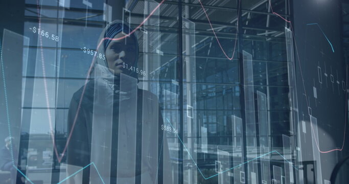 Image of financial data over biracial businesswoman walking in office