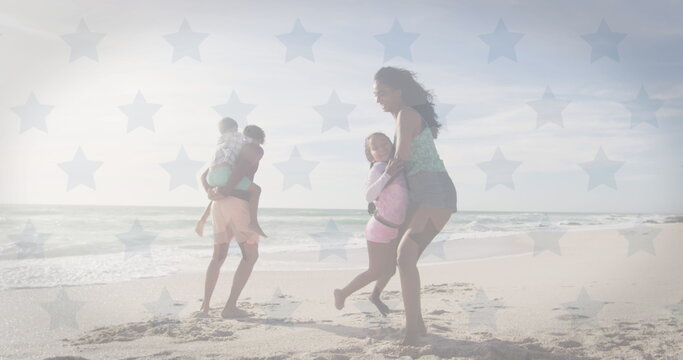 Image of flag of united states of america over biracial couple with children by seaside