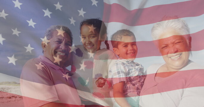 Naklejki Image of flag of united states of america over biracial couple with grandchildren on beach