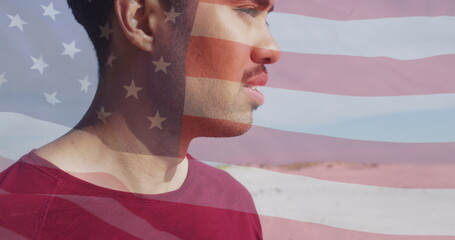 Image of flag of united states of america and biracial man on beach