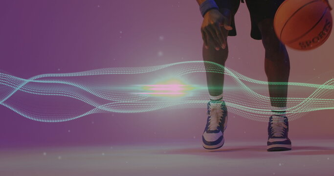 Image of mesh and neon pattern over african american basketball player - Powered by Adobe