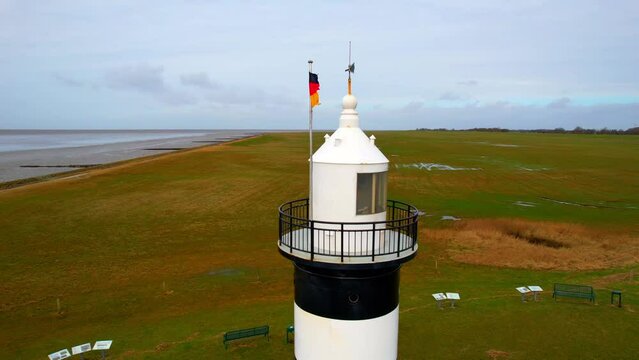 Lighthouse “Little Preusse” - Wurster North Sea Coast - Wremen - Northern Germany - 360 degree circling aerial shot around the lighthouse.