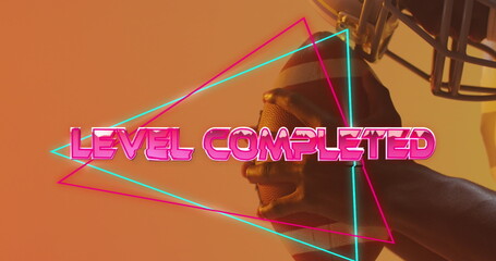 Image of level completed text over neon pattern and african american american football player