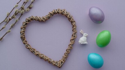 Template for greeting card or congratulation for Easter, colored easter eggs and bunny on purple background.