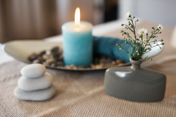 Obraz na płótnie Canvas Spa, aromatherapy and candles with plants, rocks for zen, calm and peace to relax for health or natural healing. Incense, wellness or stones for wellbeing, holistic massage or hospitality background