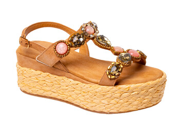Leather shoes isolated. Close-up of a single of elegant female suede sandals with rhinestones....
