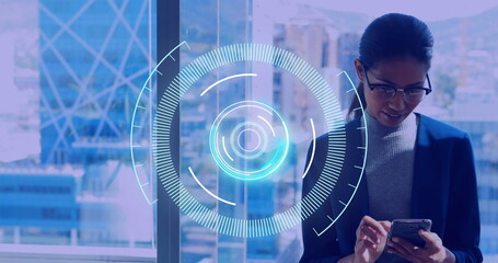 Neon round scanner against businesswoman using smartphone at office