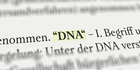 Fotobehang Das Wort DNA im Buch mit Textmarker markiert © Nico