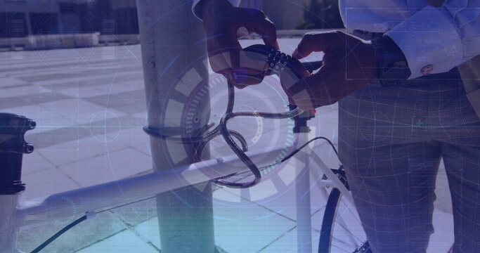 Image of data processing over african american businessman locking bike with lock chain