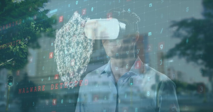 Image of cyber attack warning with caucasian man using vr headset over cityscape - Powered by Adobe
