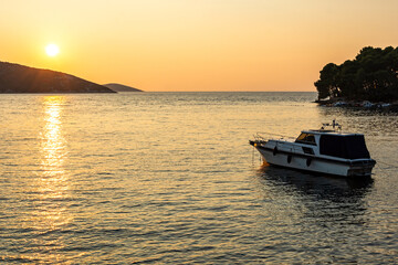 Boat anchoring in a beautiful bay (Osor) at sunset on the island of Cres-Losinj in the Adriatic Sea, Croatia