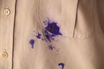 Dirty blue ink stain on shirt from using pen in daily life. dirty stain for cleaning concept