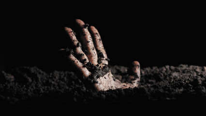 A solitary hand emerges from the soil, gripping the earth, symbolizing themes of struggle,...