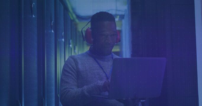 Image of financial data processing over african american man in server room