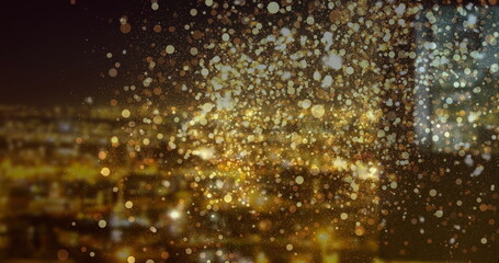 Image of golden dots over night cityscape