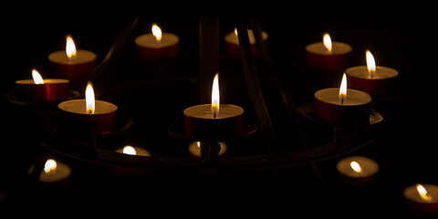 Group of red votive candle aginst a dark background