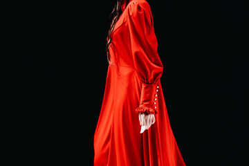 Fototapeta premium Details of a bright red long dress. Women's elegant fashion