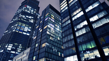Office building at night, building facade with glass and lights. View with illuminated modern skyscraper. - 757819053