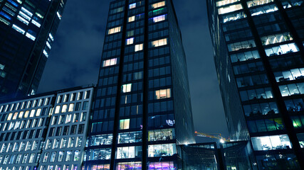 Office building at night, building facade with glass and lights. View with illuminated modern skyscraper. - 757819255