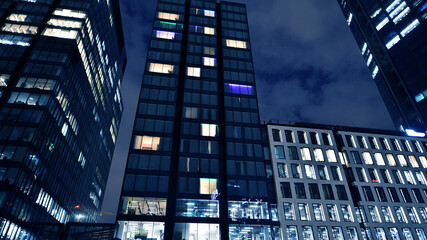 Office building at night, building facade with glass and lights. View with illuminated modern skyscraper. - 757819270