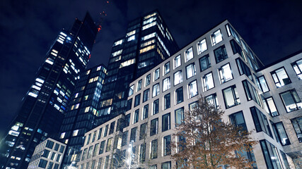 Office building at night, building facade with glass and lights. View with illuminated modern skyscraper. - 757819473