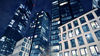 Office building at night, building facade with glass and lights. View with illuminated modern skyscraper. - 757819681